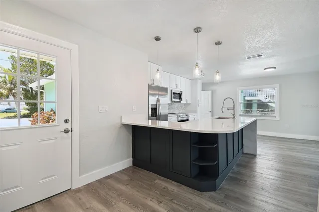 a view with cabinets wooden floor and a window