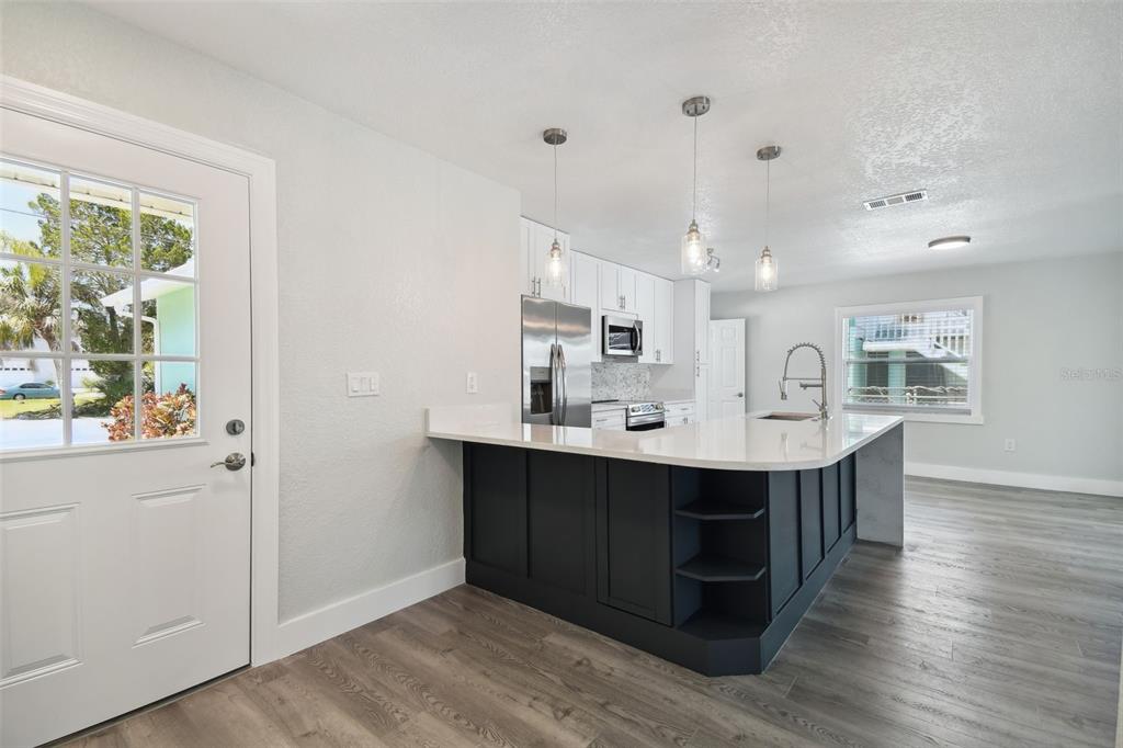 4482 Kingston Drive Hernando Beach, FL 34607 - Photo 24 of 49 a view with cabinets wooden floor and a window