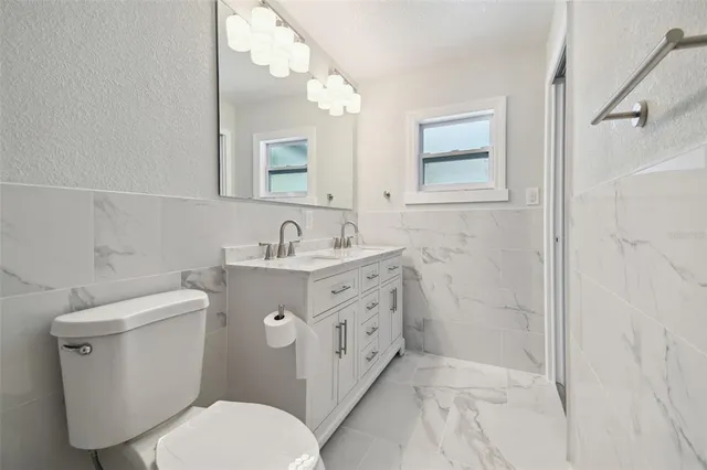 a bathroom with a toilet sink and mirror