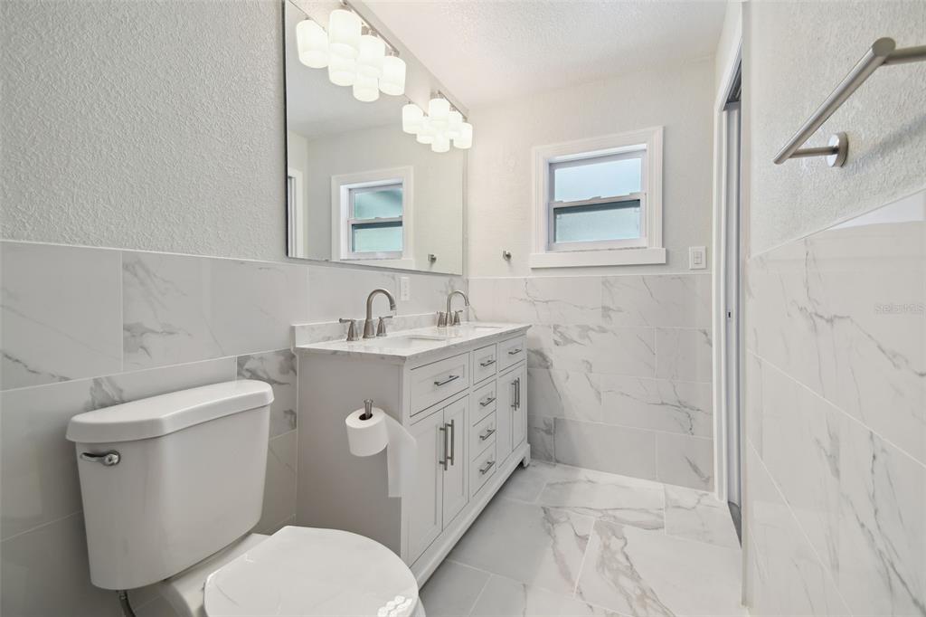 4482 Kingston Drive Hernando Beach, FL 34607 - Photo 25 of 49 a bathroom with a toilet sink and mirror