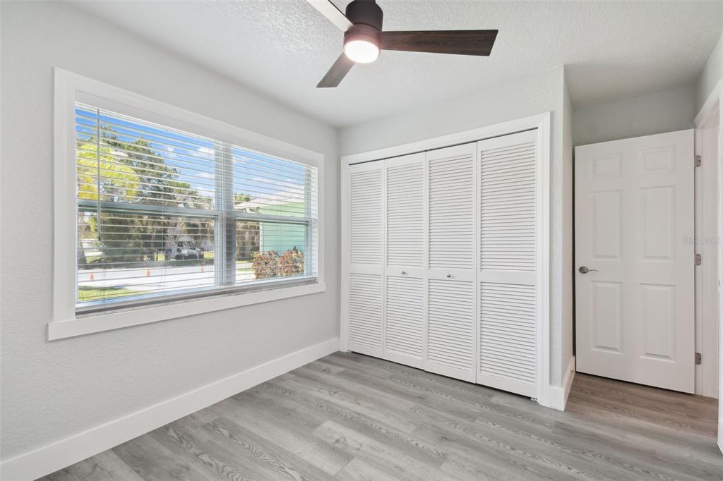 4482 Kingston Drive Hernando Beach, FL 34607 - Photo 35 of 49 a view of an empty room with wooden floor and a window