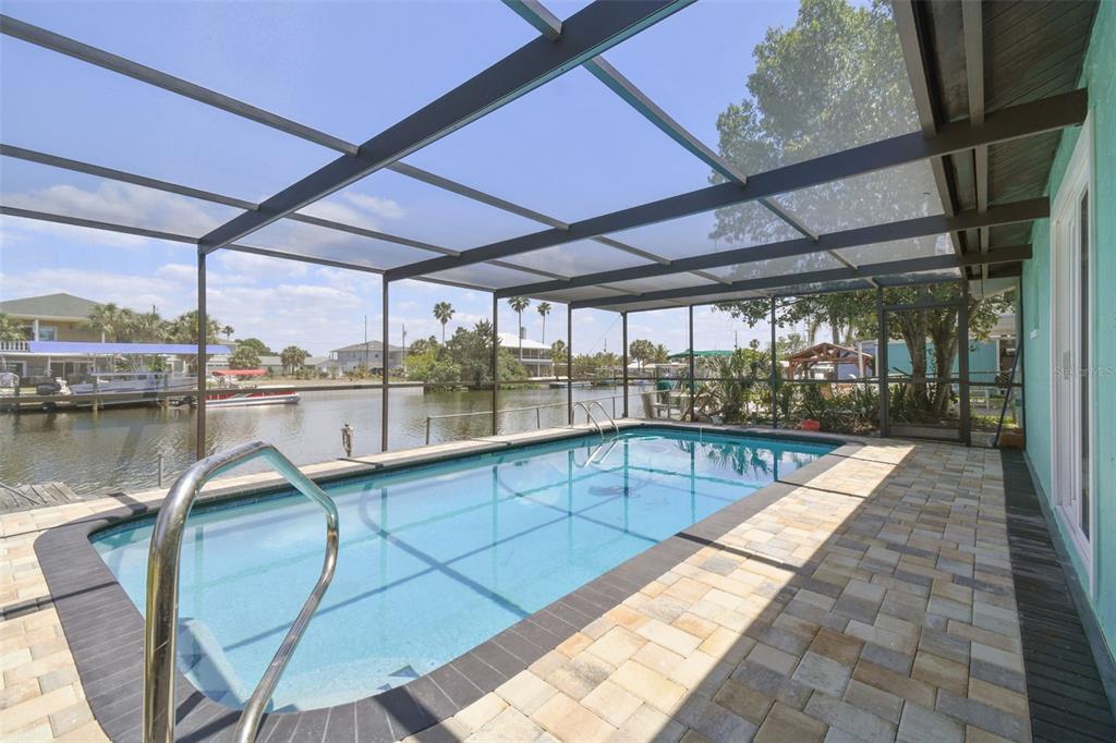 4482 Kingston Drive Hernando Beach, FL 34607 - Photo 39 of 49 a view of a swimming pool with a porch