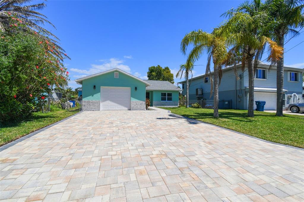 4482 Kingston Drive Hernando Beach, FL 34607 - Photo 5 of 49 a front view of a house with a yard and potted plants