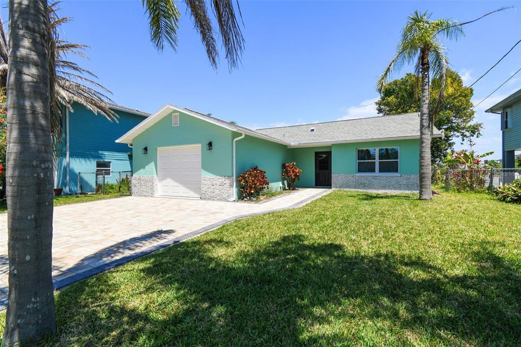 4482 Kingston Drive Hernando Beach, FL 34607 - Photo 6 of 49 a front view of a house with a yard