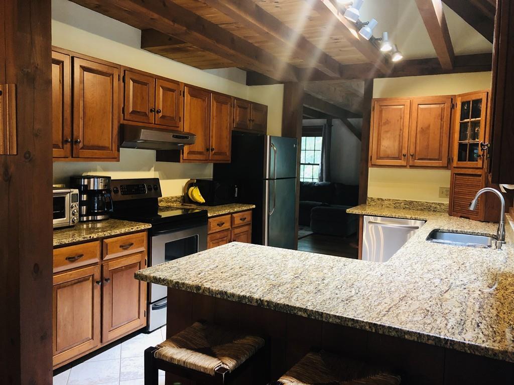 451 Carpenter Road Northbridge, MA 01588 - Photo 3 of 28 a kitchen with kitchen island granite countertop wooden cabinets a stove top oven a sink and dishwasher