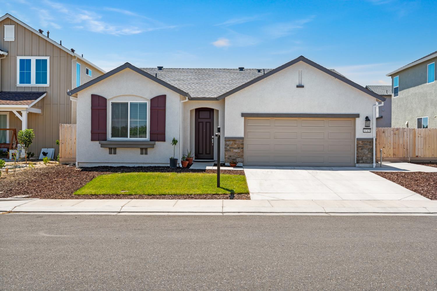 5713 Natalie Way Keyes, CA 95328 - Photo 1 of 30 a front view of house with garage and yard