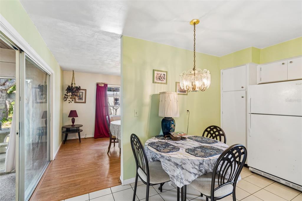 2059 Waterfall Drive Spring Hill, FL 34608 - Photo 9 of 26 a view of a dining room with furniture wooden floor and chandelier