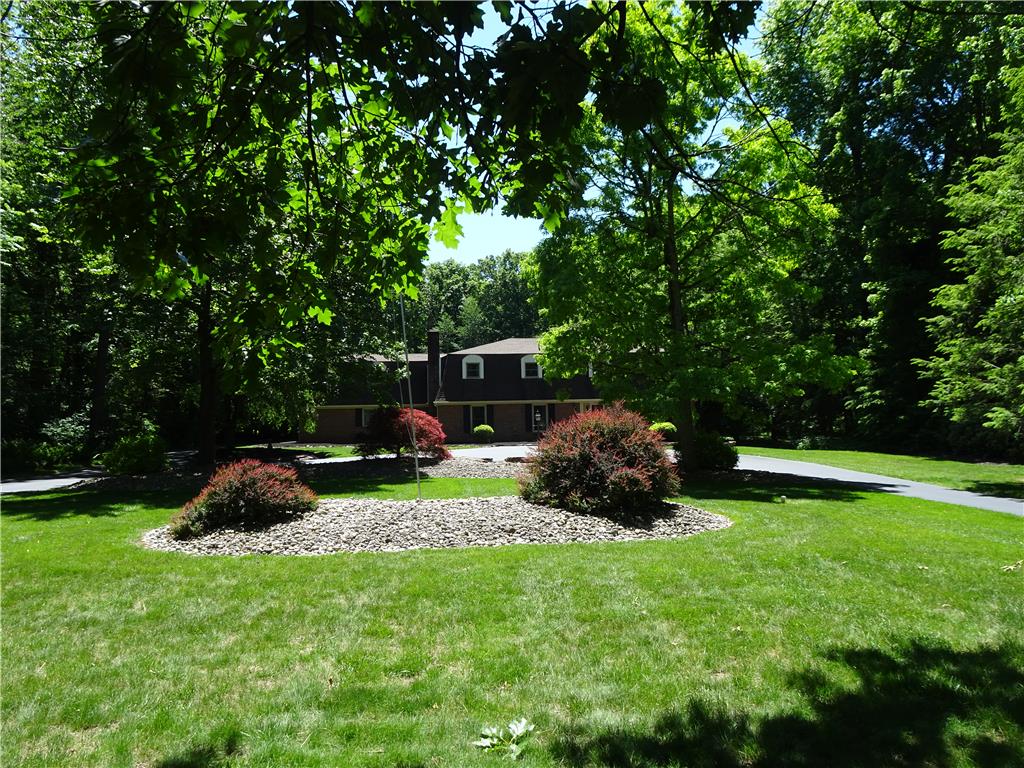1371 Stoke Park Road Bethlehem, PA 18017 - Photo 11 of 12 A verdant lawn frames a secluded residence, enveloped by mature trees and natural landscaping.