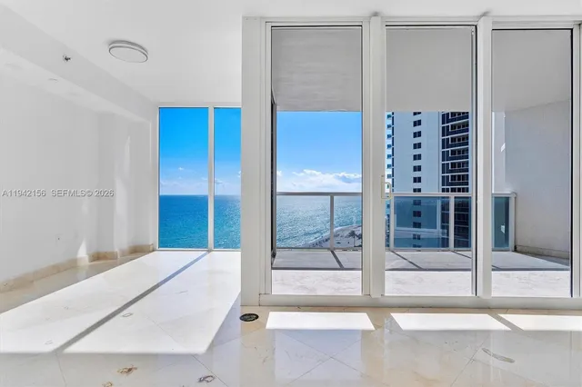 a view of a livingroom with furniture and a kitchen