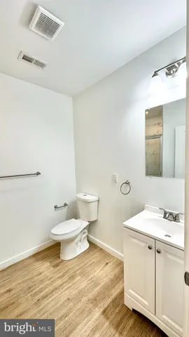 a bathroom with a toilet a sink and mirror