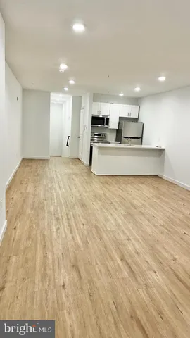 a view of kitchen with kitchen island microwave and stove