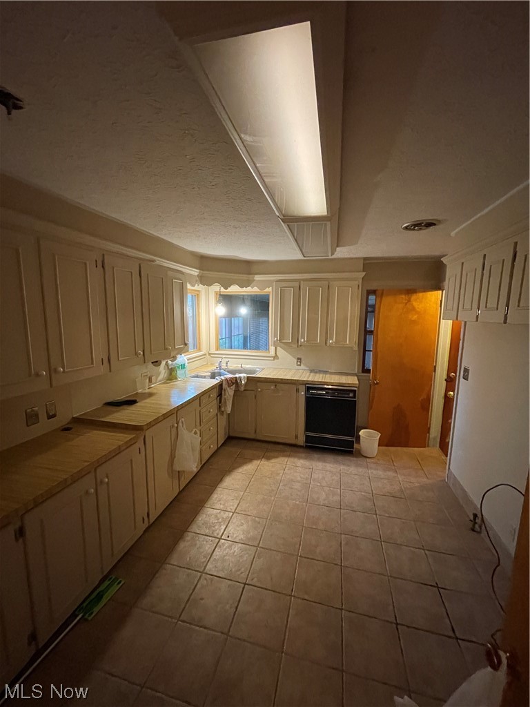 4018 Dover Road Youngstown, OH 44511 - Photo 15 of 31 Kitchen with tile counters, white cabinets, dishwashing machine, and light tile floors