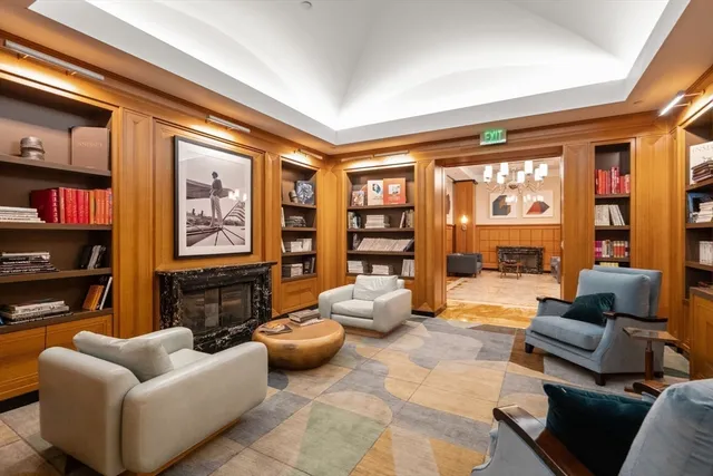 a living room with furniture a lamp and a large window