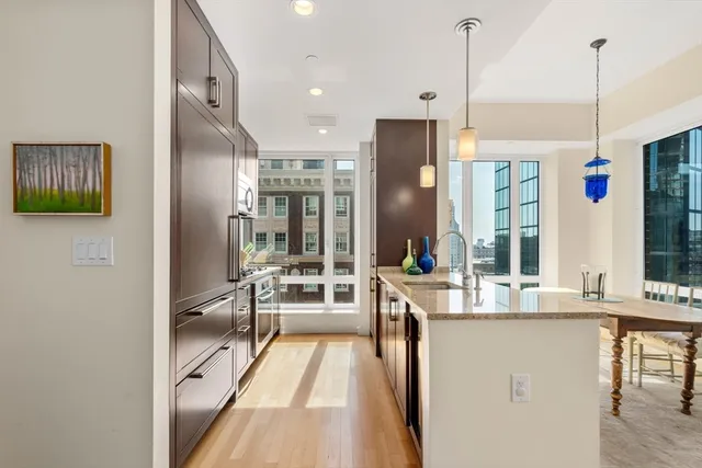 a very nice looking dining room with a large window and chandelier