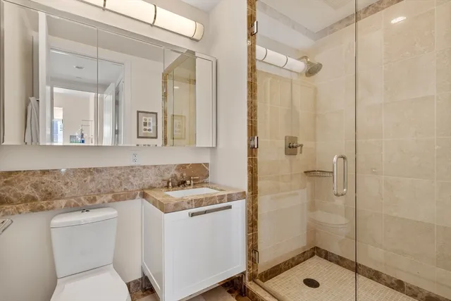 a bathroom with a sink toilet and shower