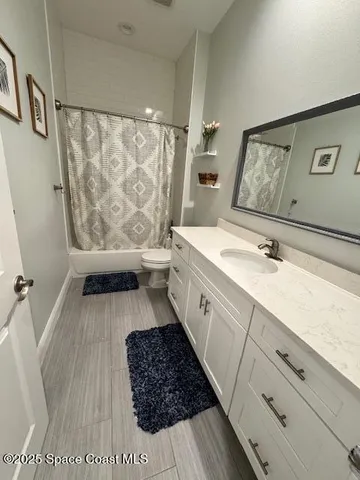 a bathroom with a sink a mirror and a toilet
