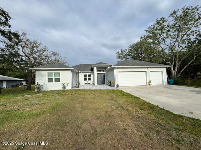 4235 Navel Street Cocoa, FL 32926 - Photo 2 of 24 a front view of house with yard and trees