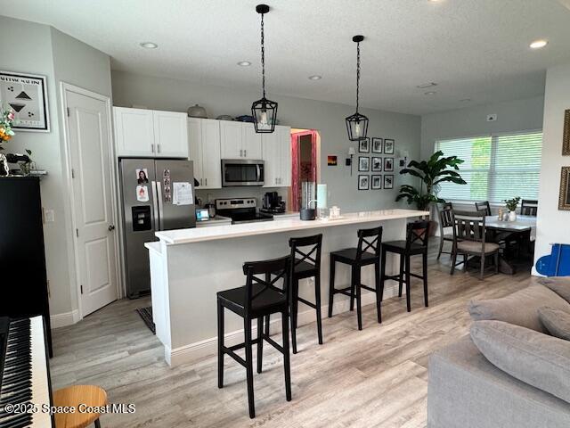 4235 Navel Street Cocoa, FL 32926 - Photo 5 of 24 a kitchen with kitchen island a dining table chairs a sink and a window