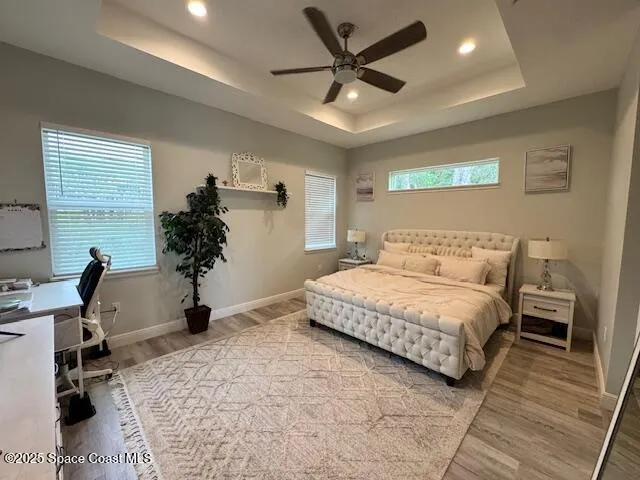 a spacious bedroom with a bed and a desk