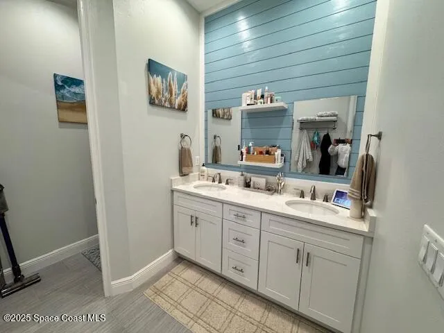 a bathroom with a double vanity sink and a mirror