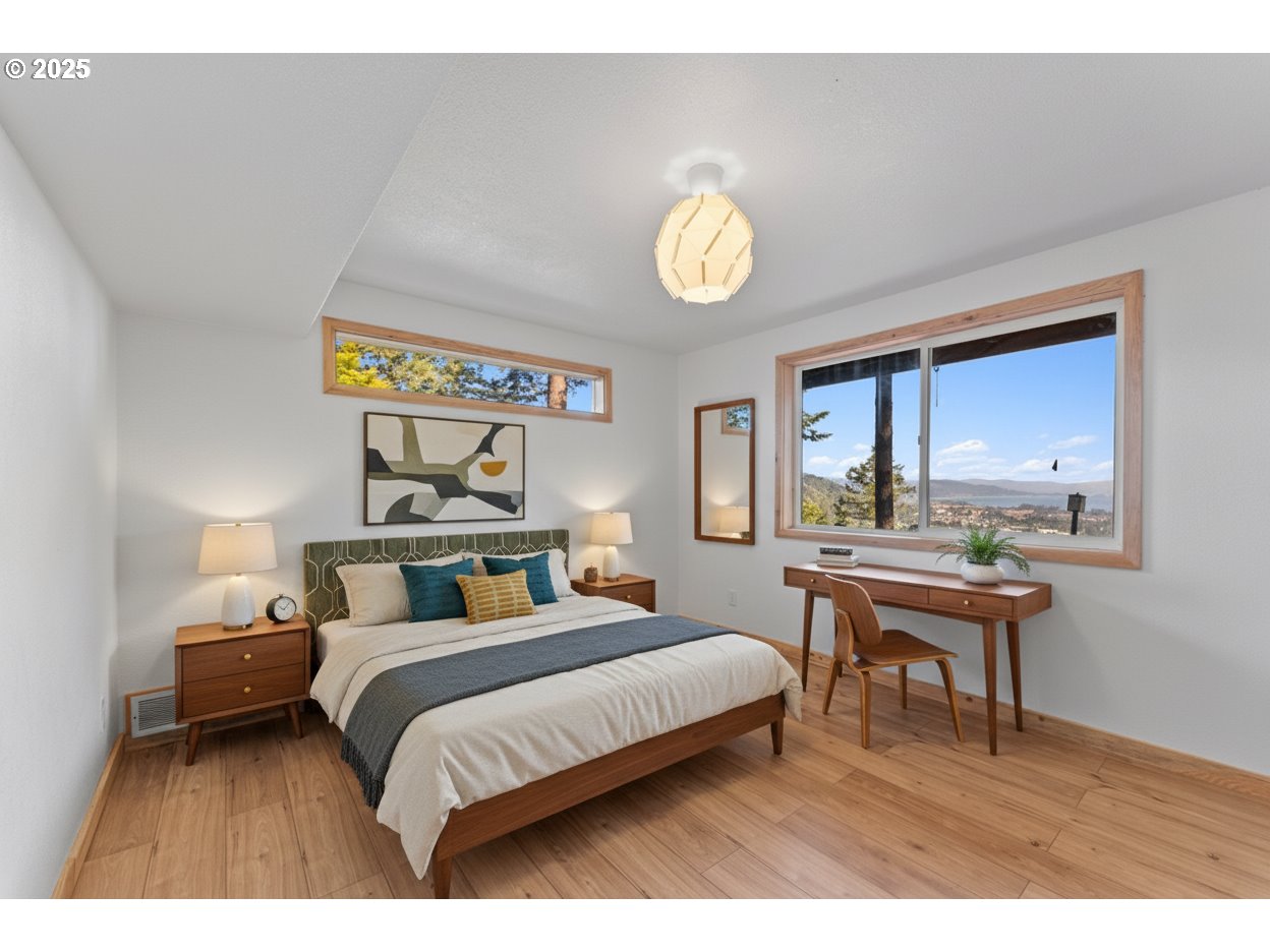 97639 Marina Heights Loop Brookings, OR 97415 - Photo 24 of 27 a bedroom with a bed and a table in it