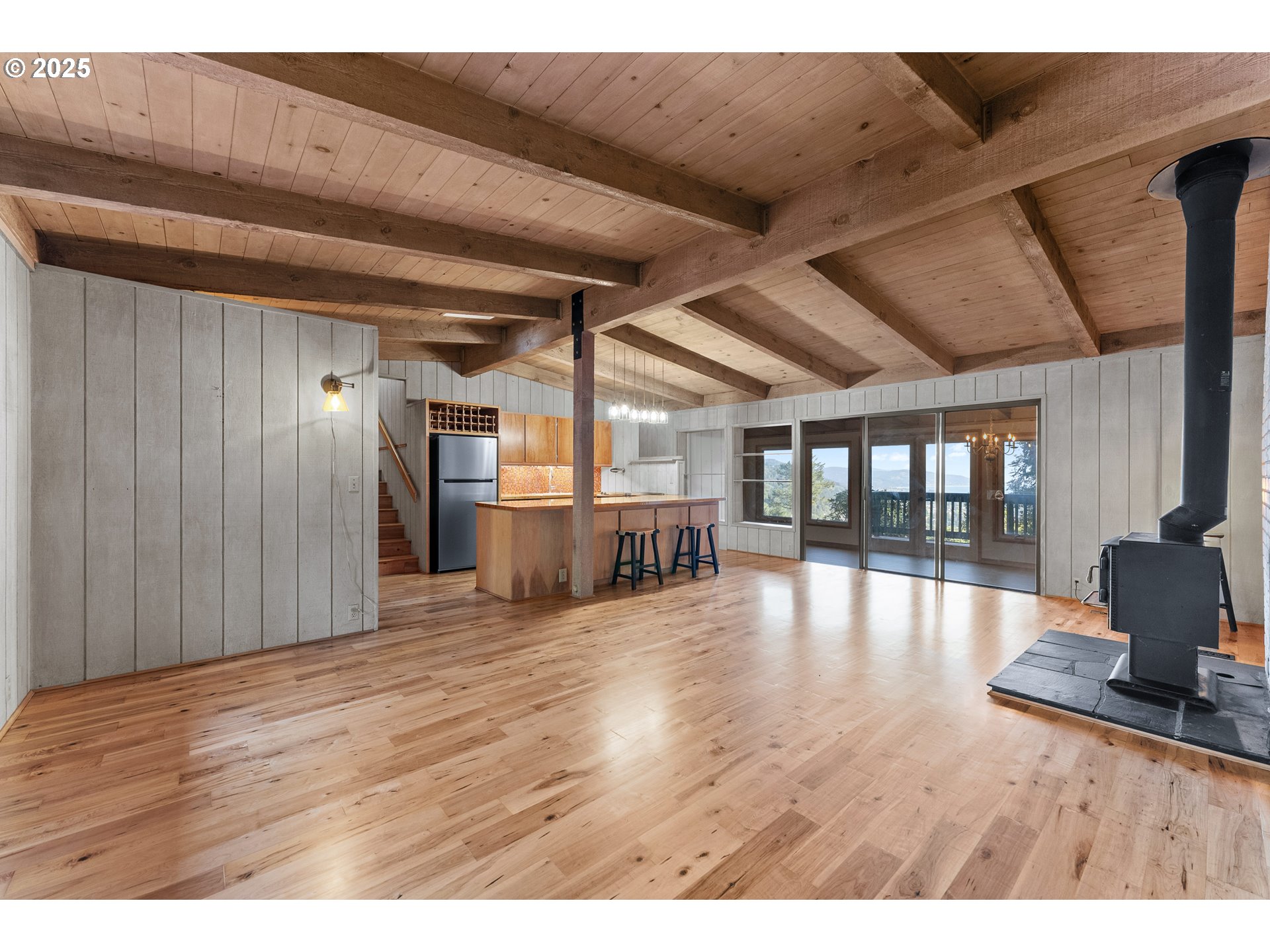 97639 Marina Heights Loop Brookings, OR 97415 - Photo 4 of 27 a view of empty room with wooden floor and fan