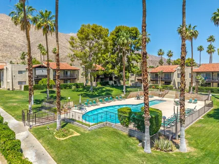 a view of a patio with a table and chairs under an umbrella