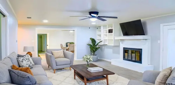 a living room with furniture a fireplace and a flat screen tv