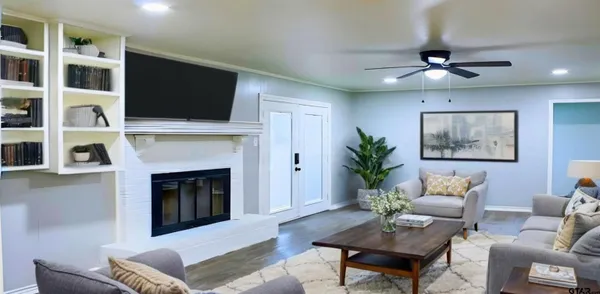 a living room with furniture fireplace and flat screen tv