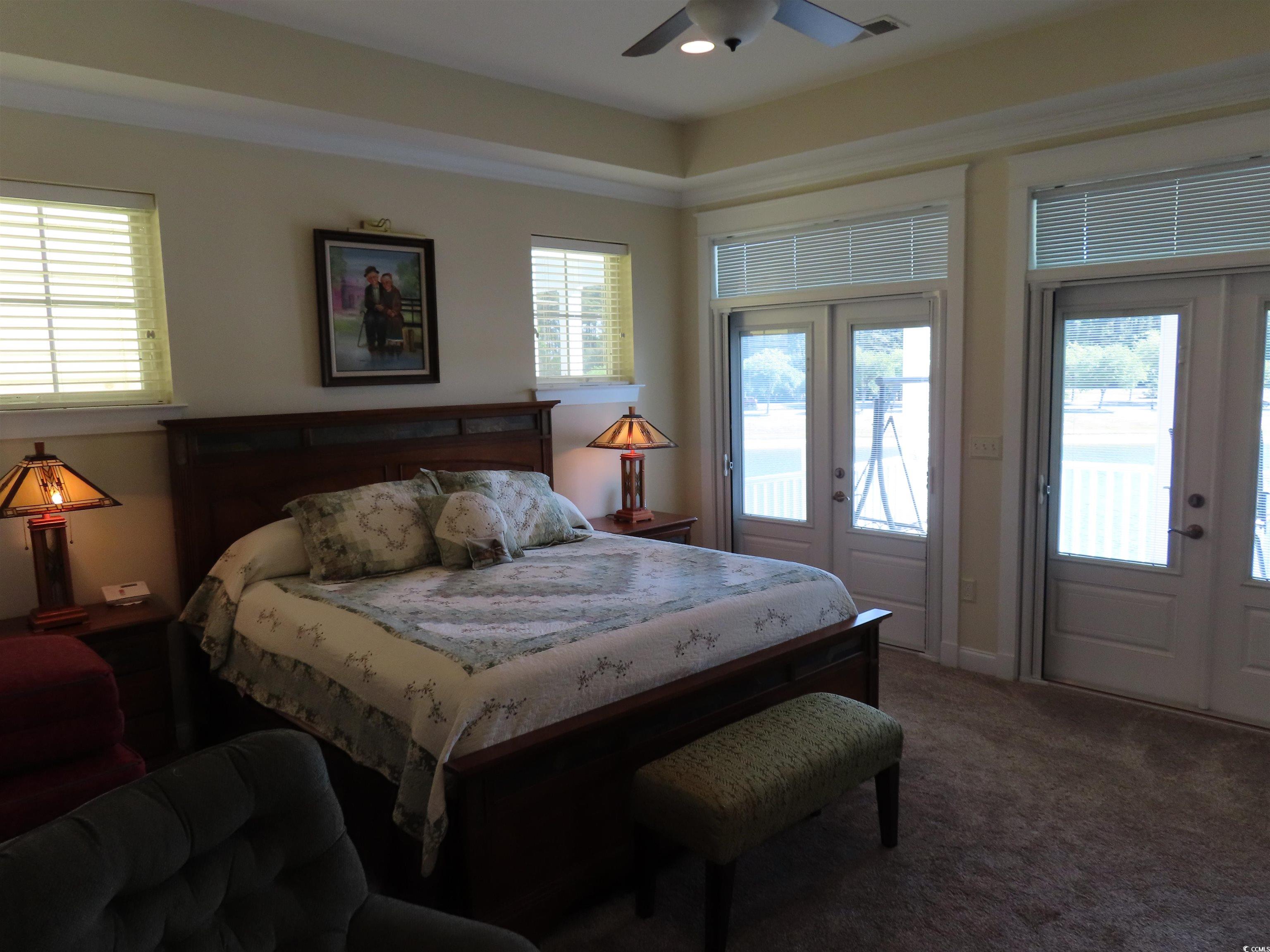 800 Curtis Brown Lane Myrtle Beach, SC 29577 - Photo 22 of 40 Bedroom featuring french doors, access to outside, dark colored carpet, and a ceiling fan