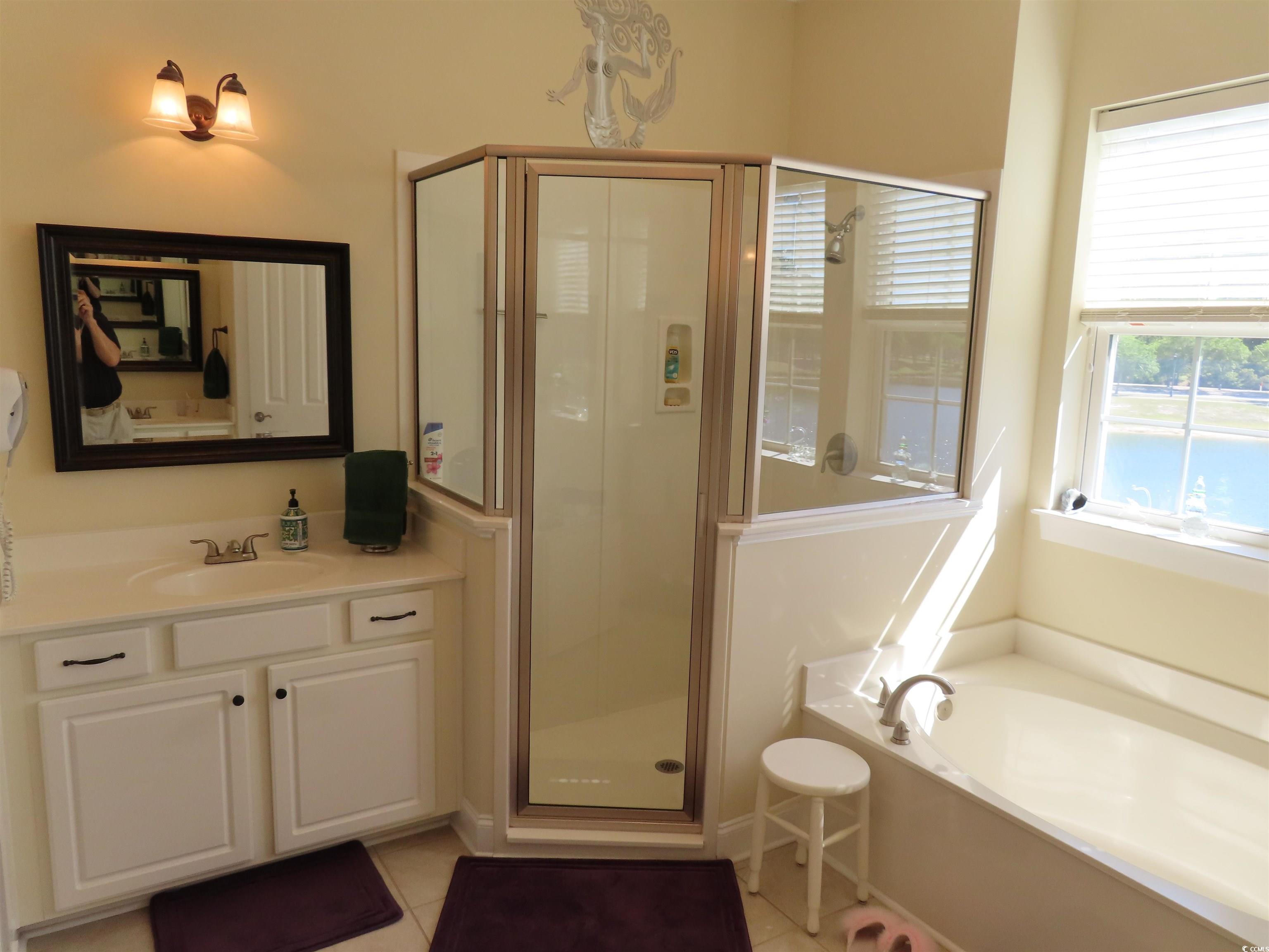 800 Curtis Brown Lane Myrtle Beach, SC 29577 - Photo 25 of 40 Full bathroom with a stall shower, a garden tub, vanity, and light tile patterned floors