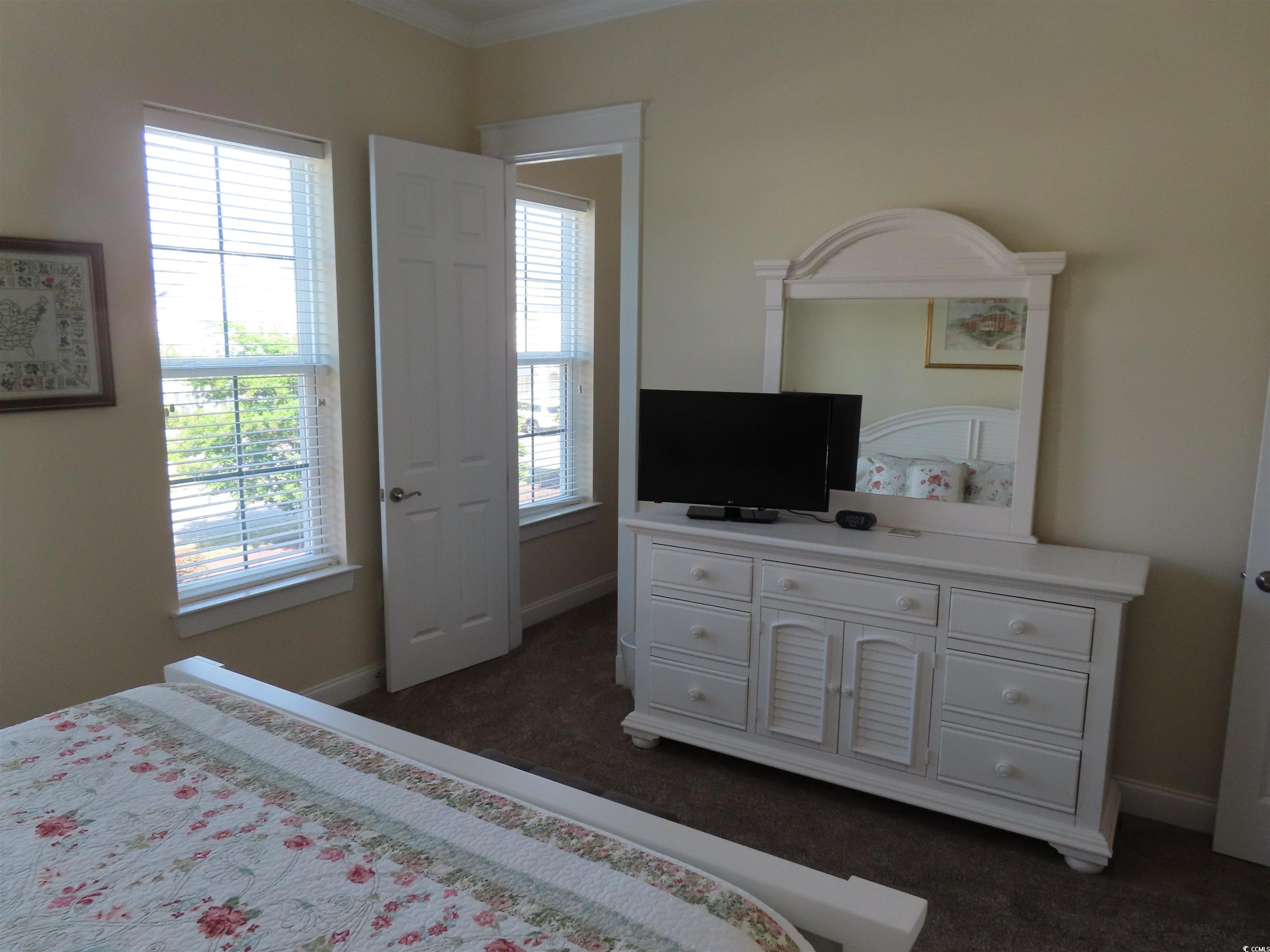 800 Curtis Brown Lane Myrtle Beach, SC 29577 - Photo 31 of 40 Bedroom featuring dark colored carpet and ornamental molding