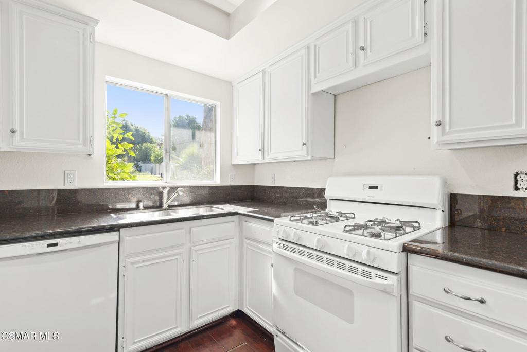 1258 Ramona Drive Newbury Park, CA 91320 - Photo 13 of 51 a kitchen with granite countertop white cabinets and white appliances