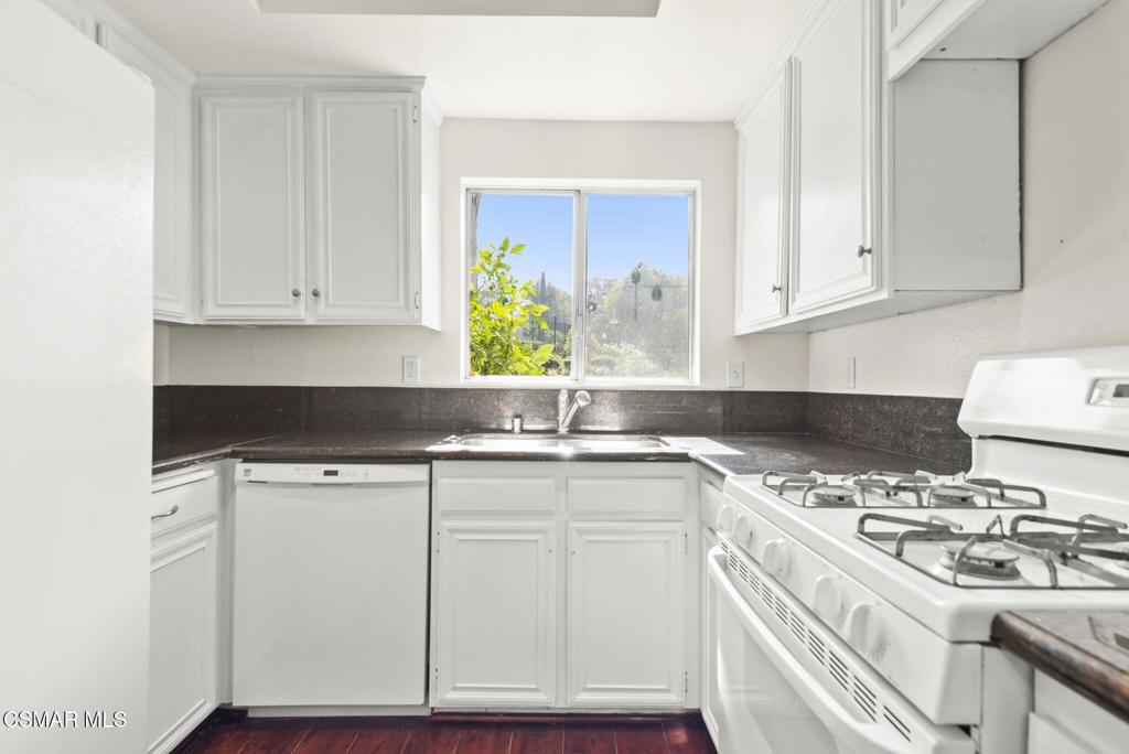 1258 Ramona Drive Newbury Park, CA 91320 - Photo 14 of 51 a kitchen with granite countertop a stove sink and cabinets
