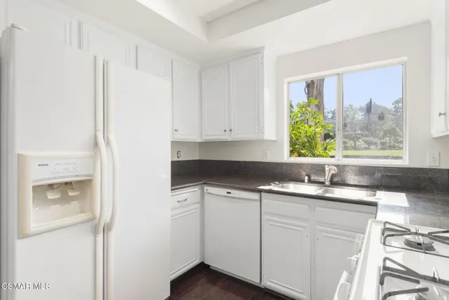 a kitchen with a stove a sink and a refrigerator