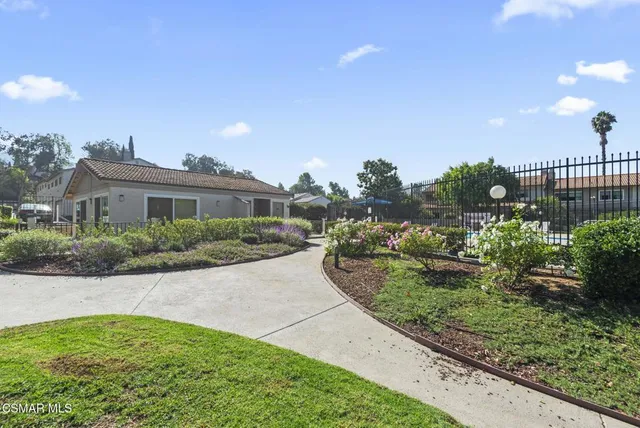a view of a house with a yard and a garage