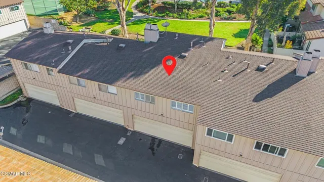 an aerial view of residential house and sandy dunes