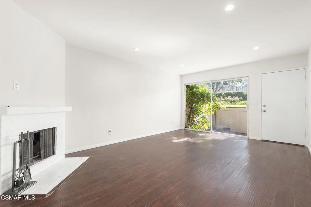 1258 Ramona Drive Newbury Park, CA 91320 - Photo 10 of 51 an empty room with wooden floor and fireplace