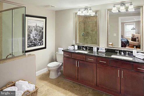 6301 Edsall Road, Unit 519 Alexandria, VA 22312 - Photo 3 of 13 a bathroom with a toilet a sink and mirror