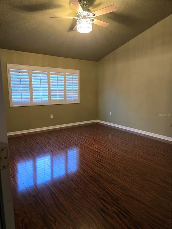 11229 Kapok Grand Circle Madeira Beach, FL 33708 - Photo 12 of 23 a view of empty room with wooden floor and fan
