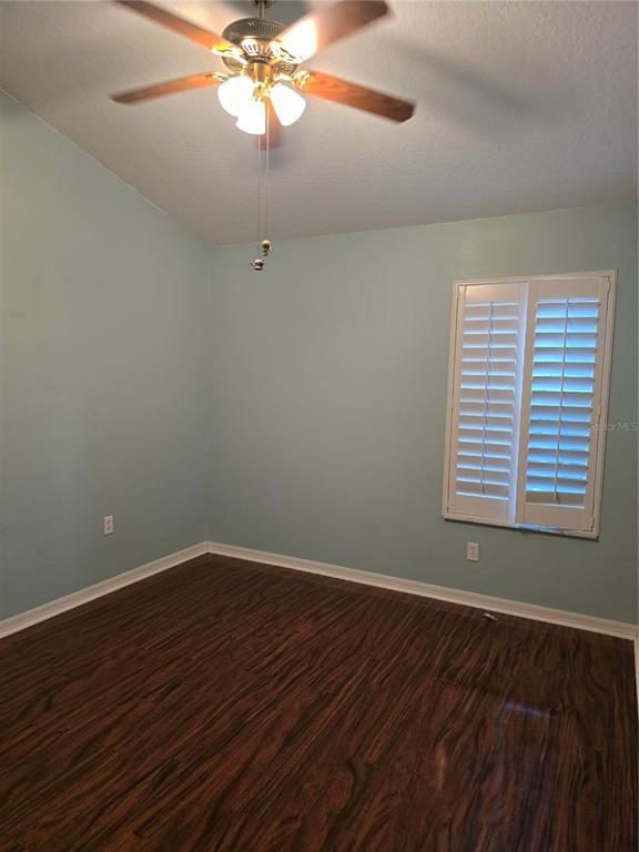 11229 Kapok Grand Circle Madeira Beach, FL 33708 - Photo 15 of 23 a view of an empty room with wooden floor and a window