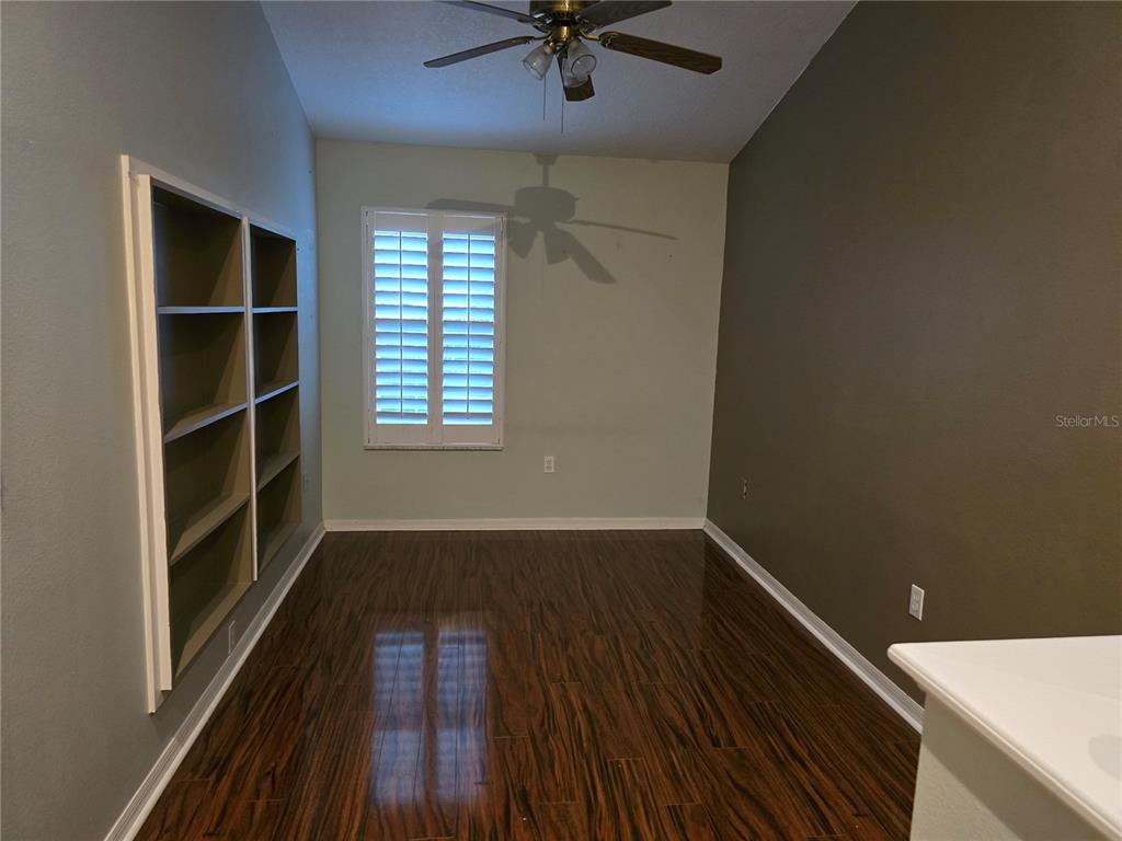 11229 Kapok Grand Circle Madeira Beach, FL 33708 - Photo 16 of 23 wooden floor in an empty room with a window