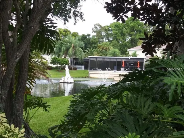 a view of swimming pool with outdoor space and lake view
