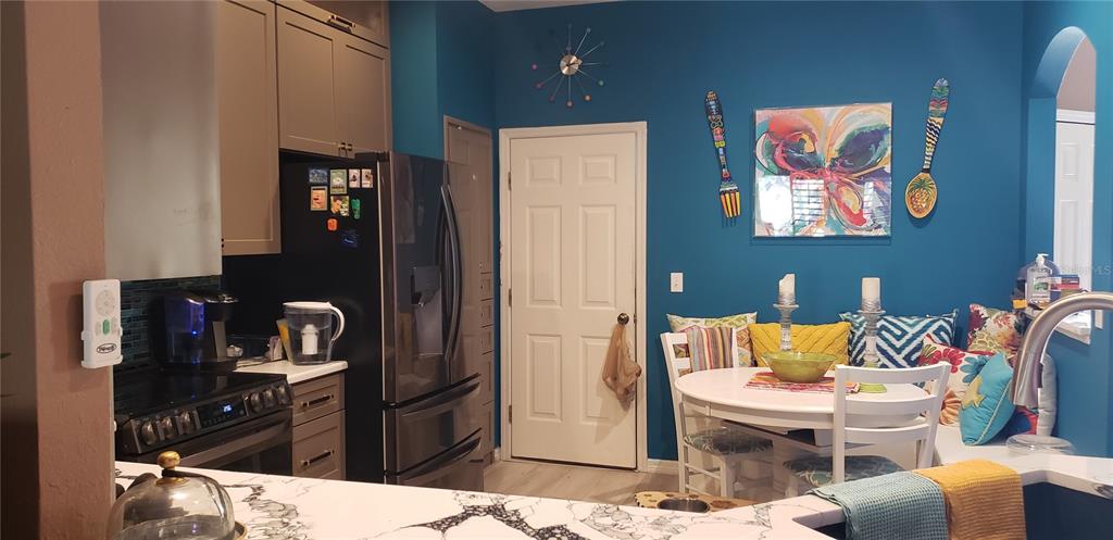 11229 Kapok Grand Circle Madeira Beach, FL 33708 - Photo 5 of 23 a living room with stainless steel appliances kitchen island granite countertop furniture and a view of kitchen