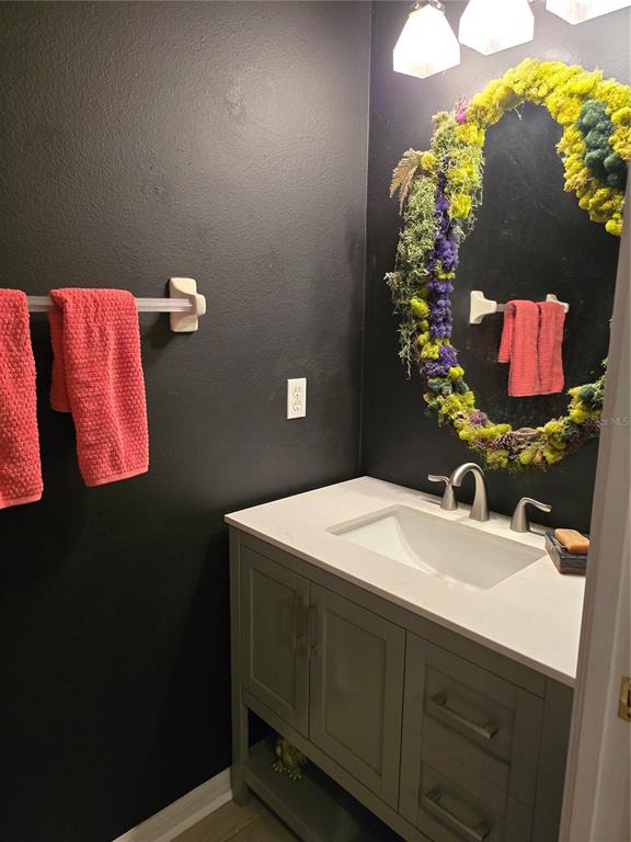 11229 Kapok Grand Circle Madeira Beach, FL 33708 - Photo 6 of 23 a bathroom with a sink and mirror