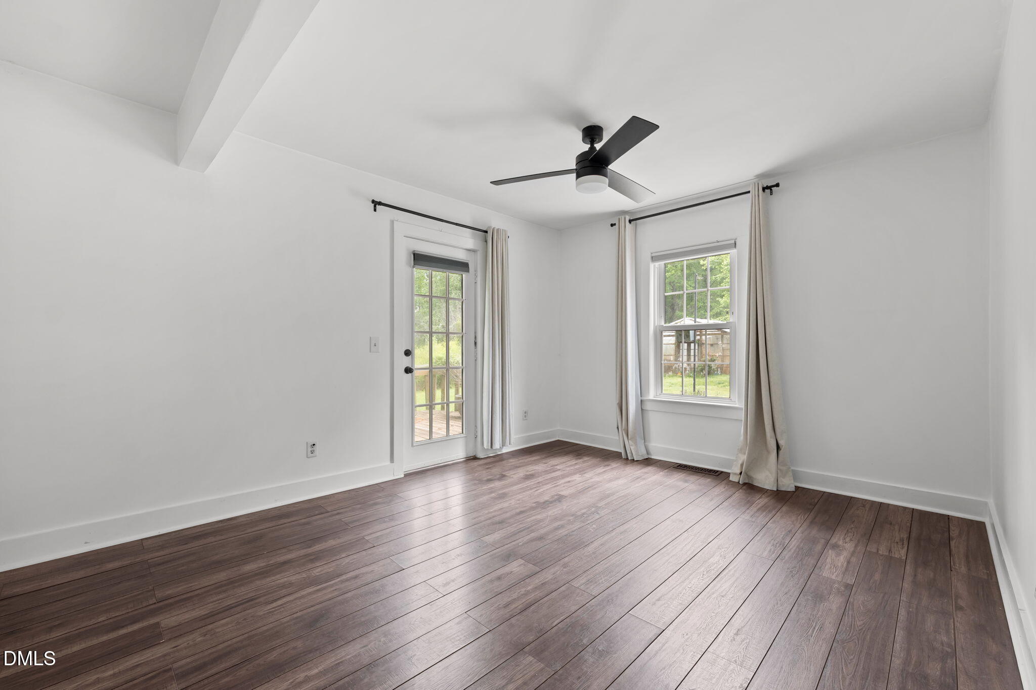 8718 Moody Road Liberty, NC 27298 - Photo 16 of 52 a view of an empty room with wooden floor and a window