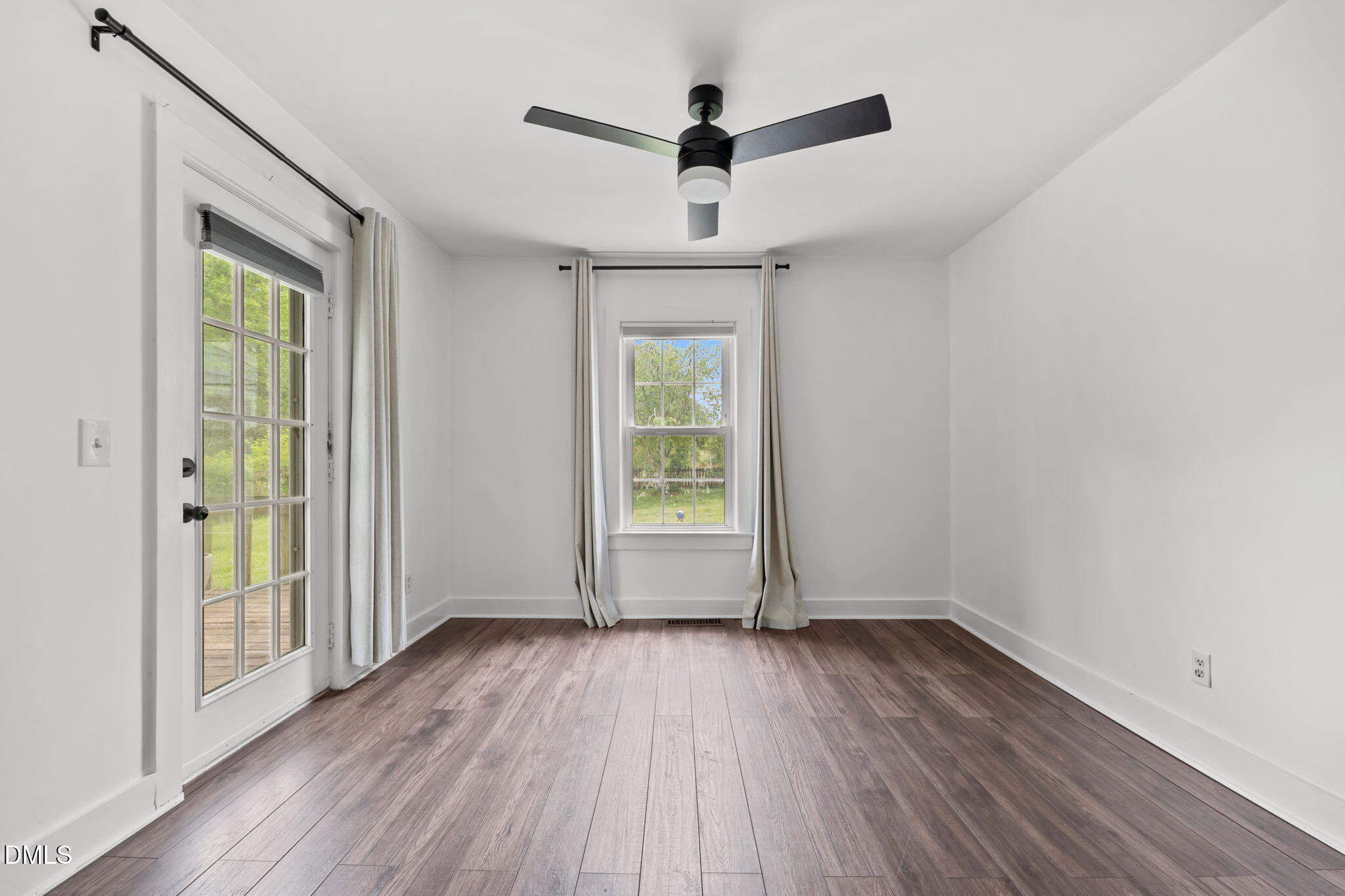 8718 Moody Road Liberty, NC 27298 - Photo 17 of 52 a view of empty room with wooden floor and fan
