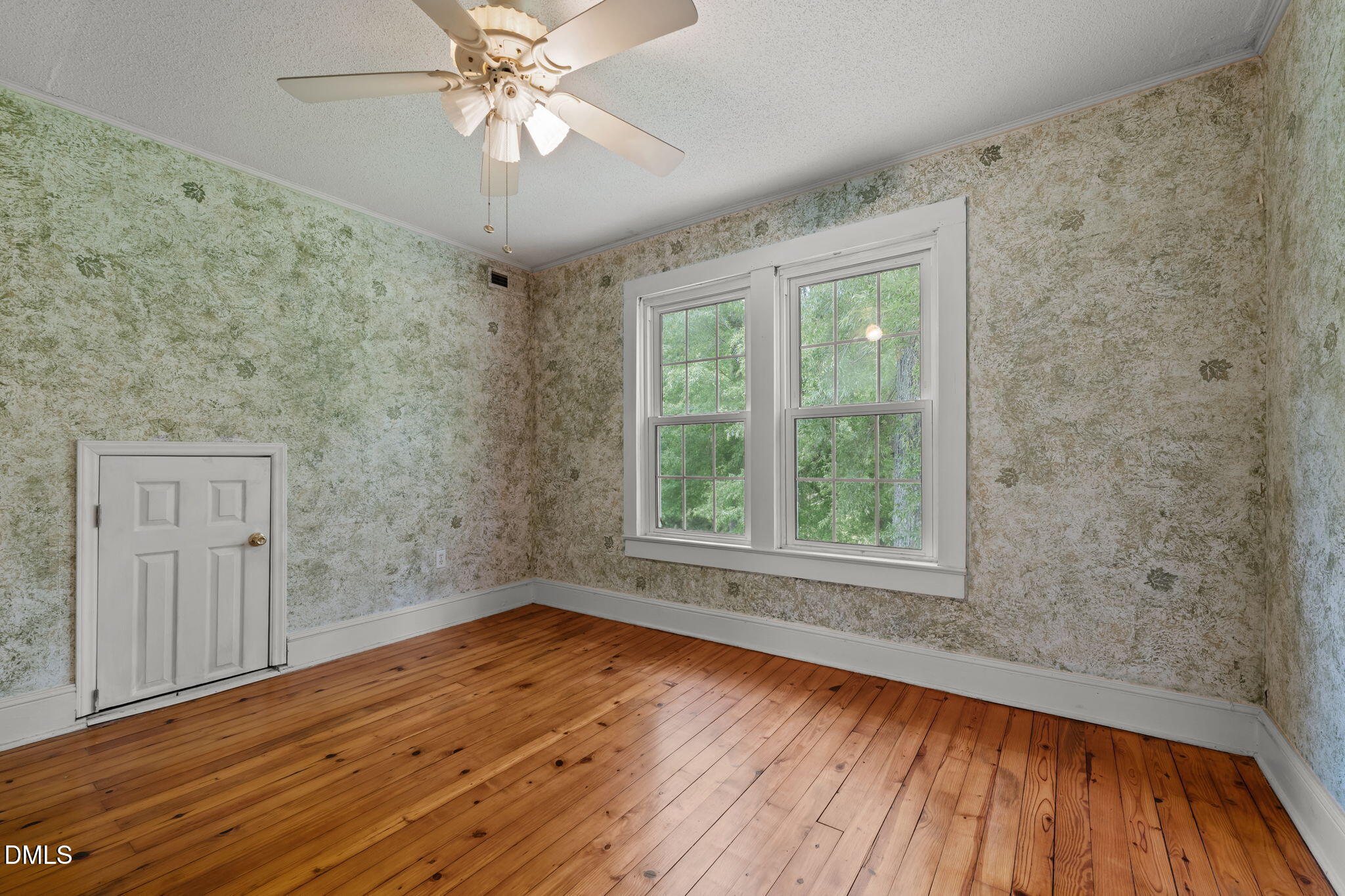 8718 Moody Road Liberty, NC 27298 - Photo 19 of 52 a view of an empty room with wooden floor and a window