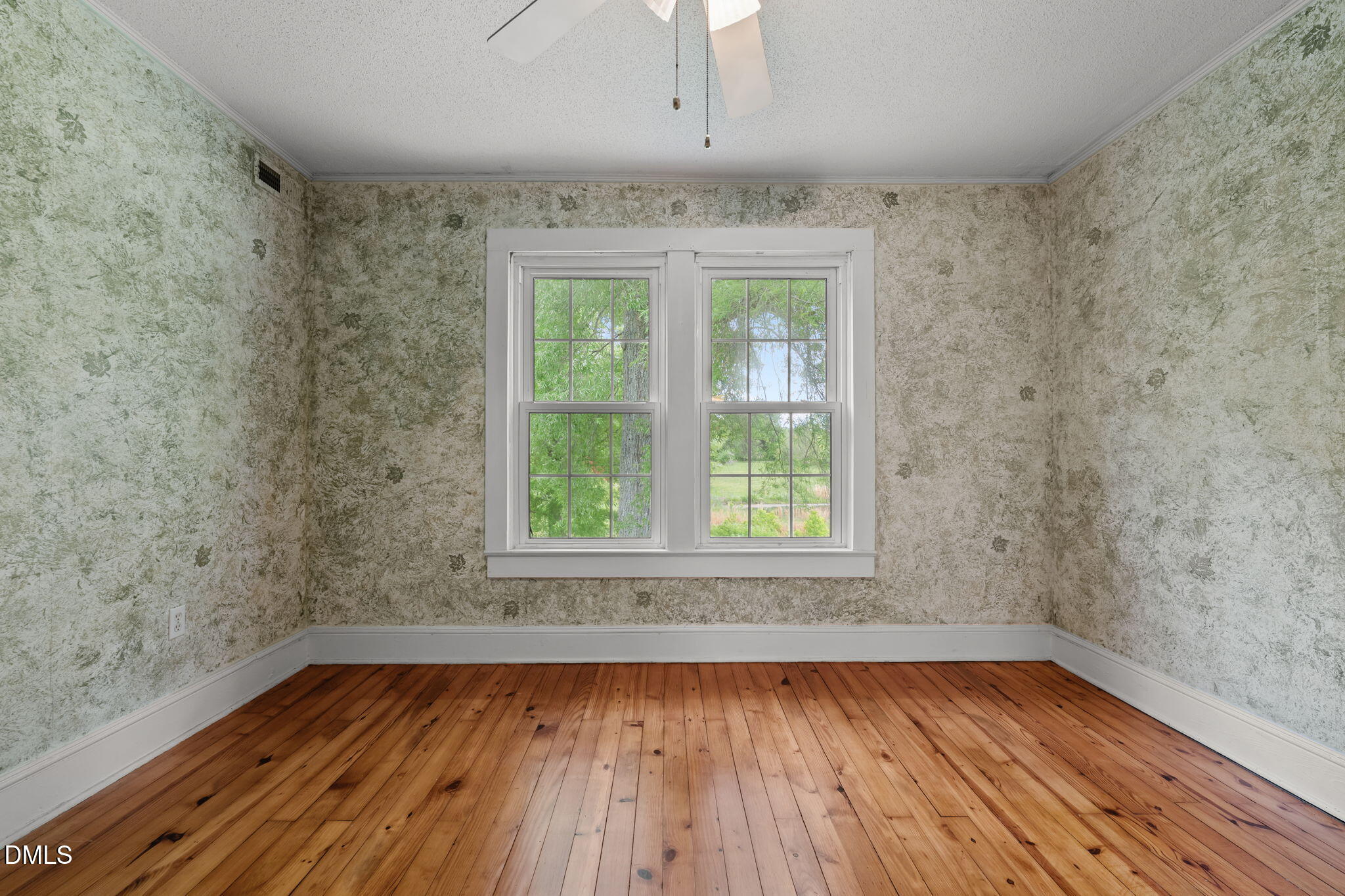8718 Moody Road Liberty, NC 27298 - Photo 20 of 52 an empty room with wooden floor and windows