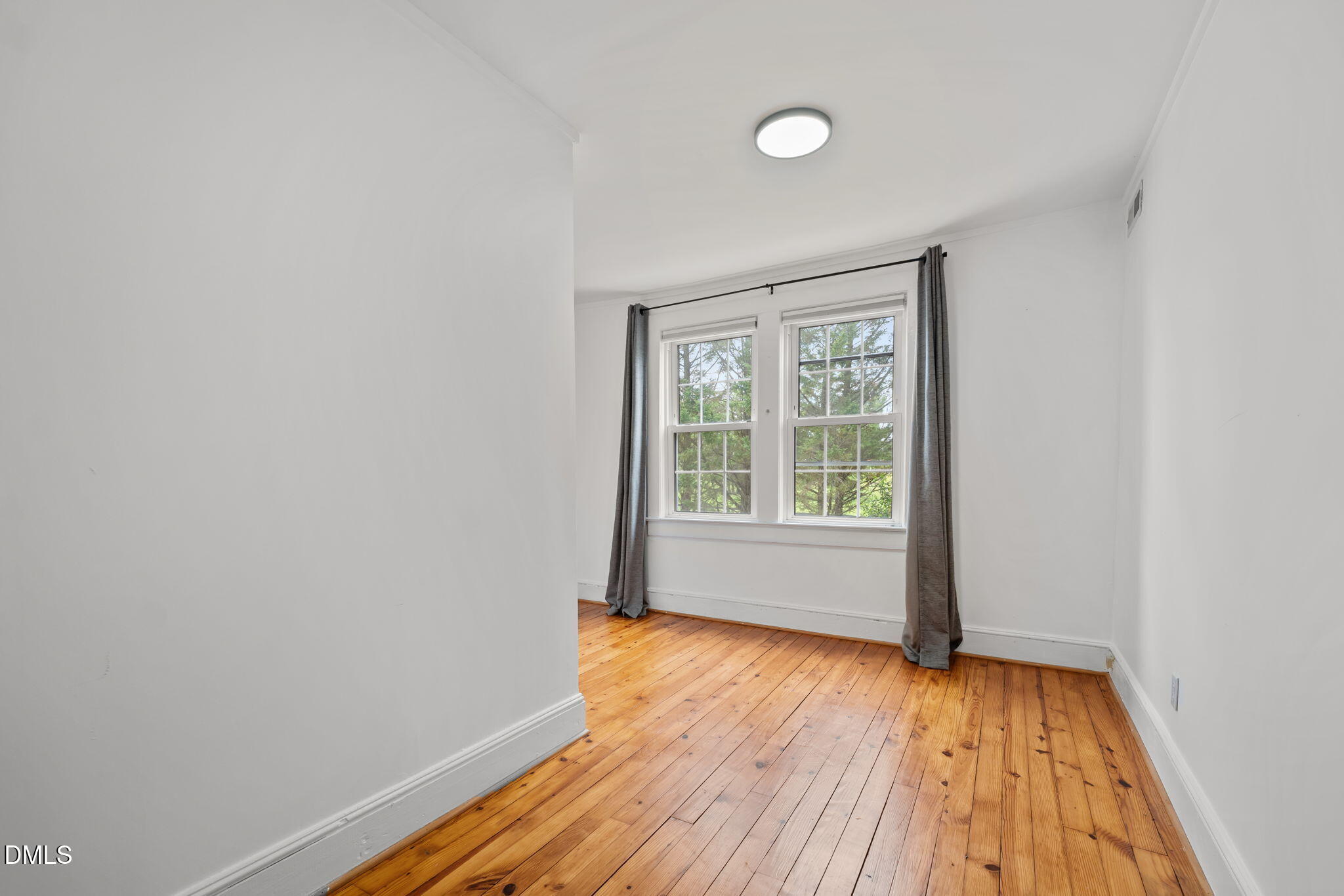 8718 Moody Road Liberty, NC 27298 - Photo 23 of 52 a view of an empty room with wooden floor and a window